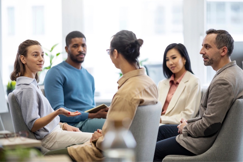 A small team talking through a project in a bright office
