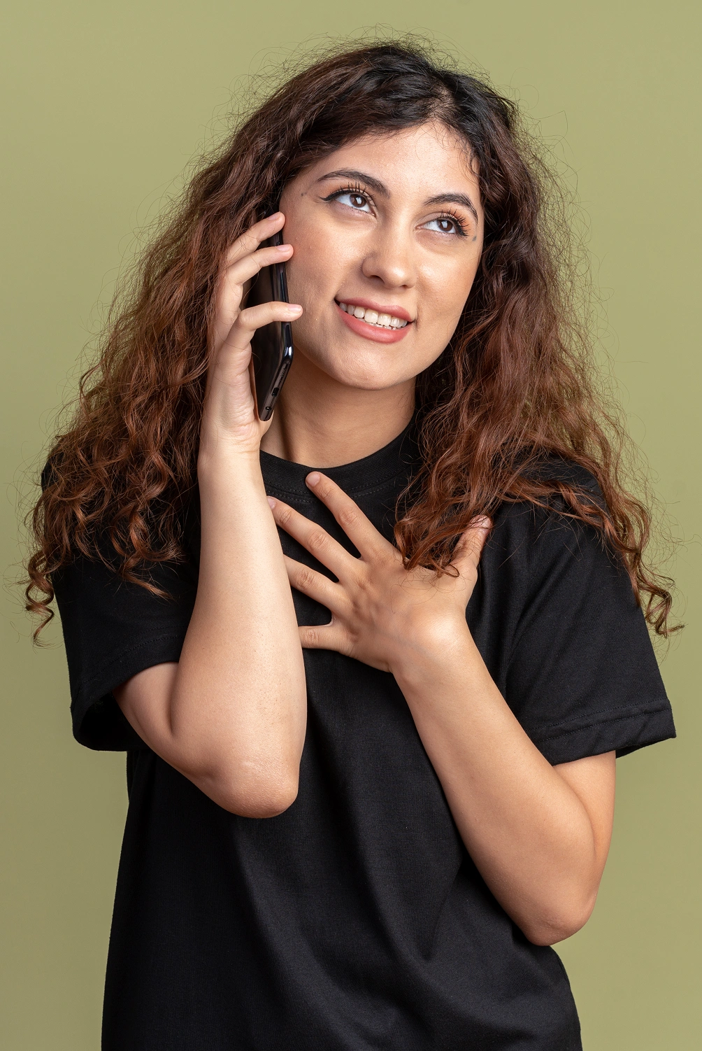 A client smiling during a phone call about her new website