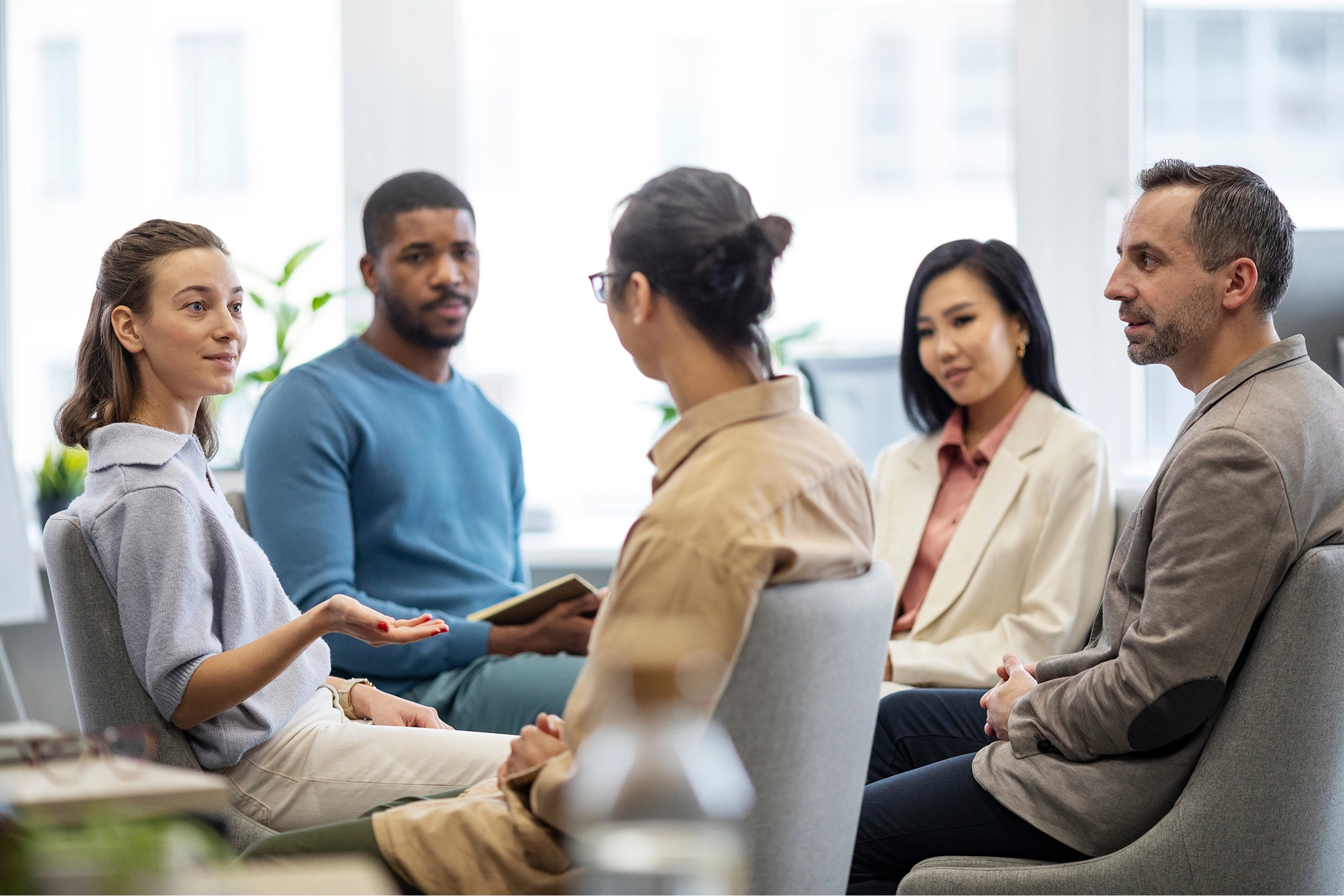 A team in conversation around a table in an open office